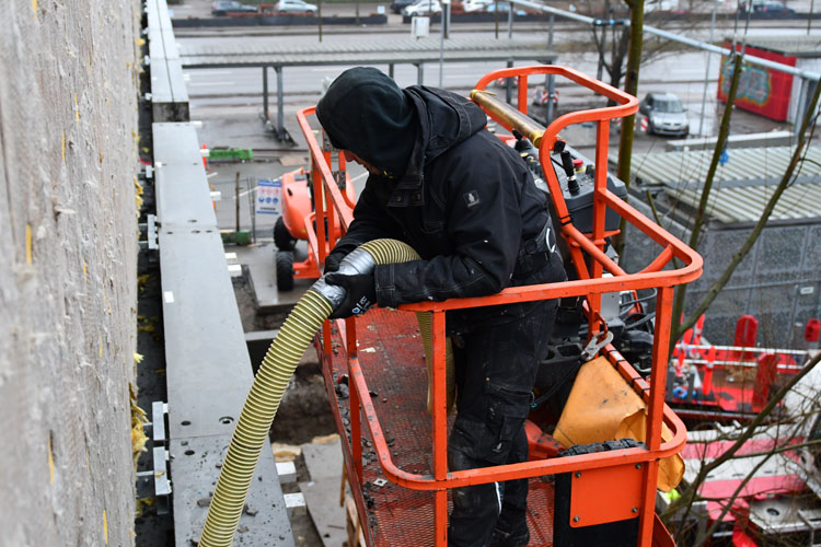 blowing insulation from a lift with CM2400 